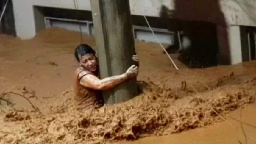 mulher-se-emociona-apos-sobreviver-em-mg-agarrada-a-poste;-video